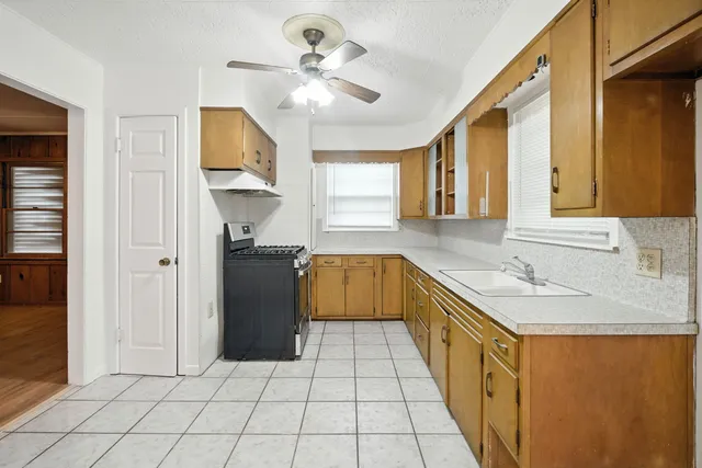 a kitchen with a sink a counter top space and cabinets
