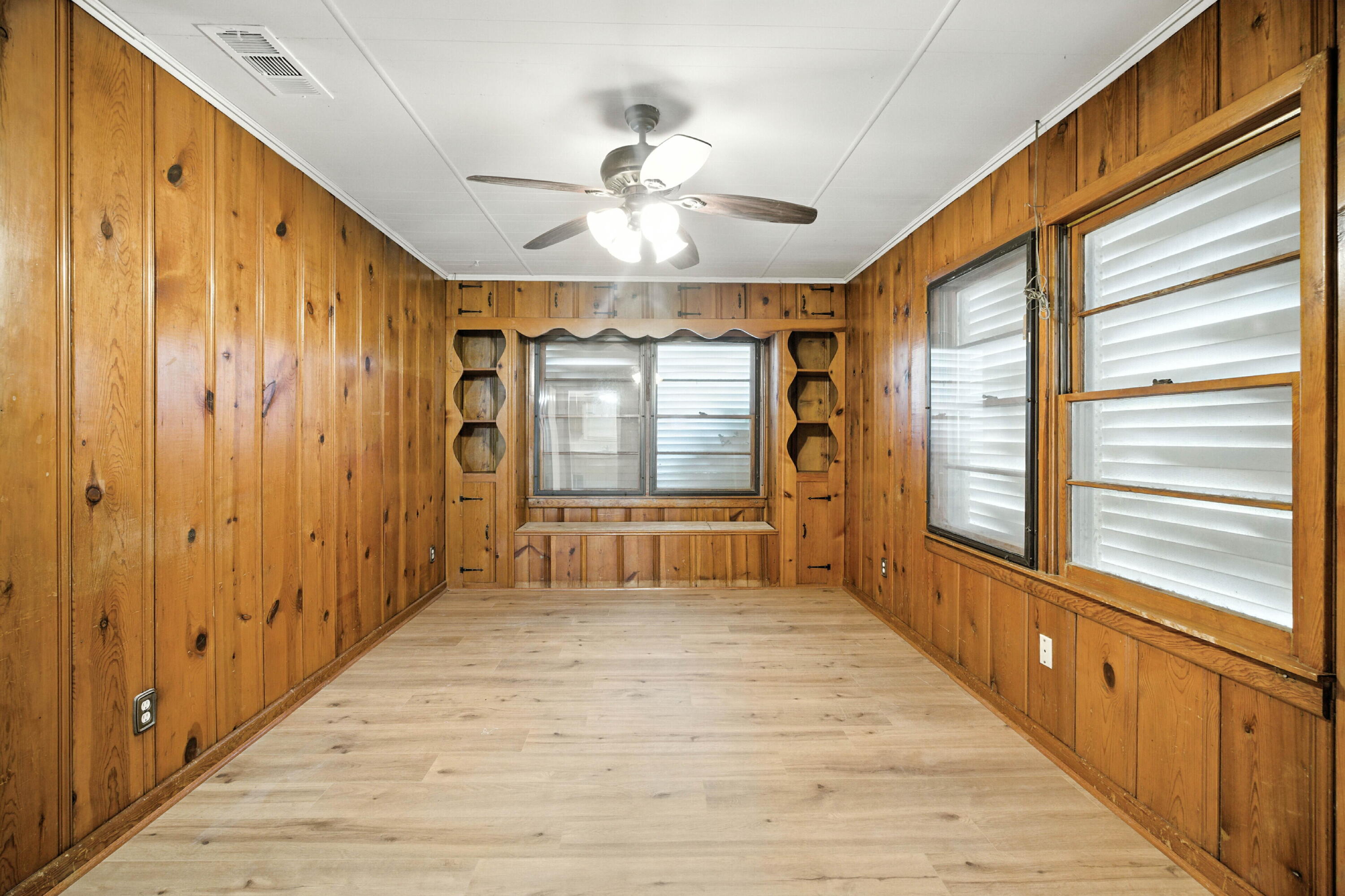 4316 31st Street Lubbock, TX 79410 - Photo 5 of 12 a view of a hallway with wooden floor and chandelier
