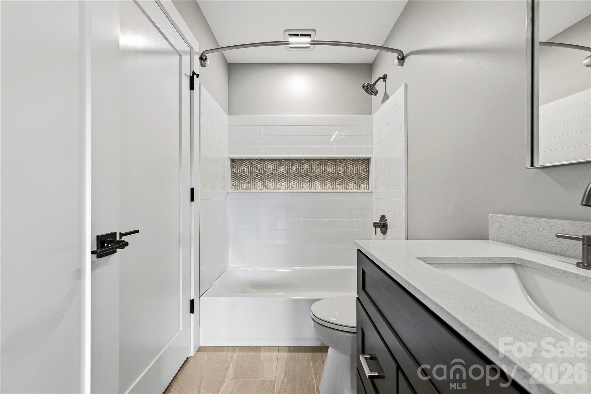 326 Emma Road Asheville, NC 28806 - Photo 11 of 15 a bathroom with a sink a toilet and shower