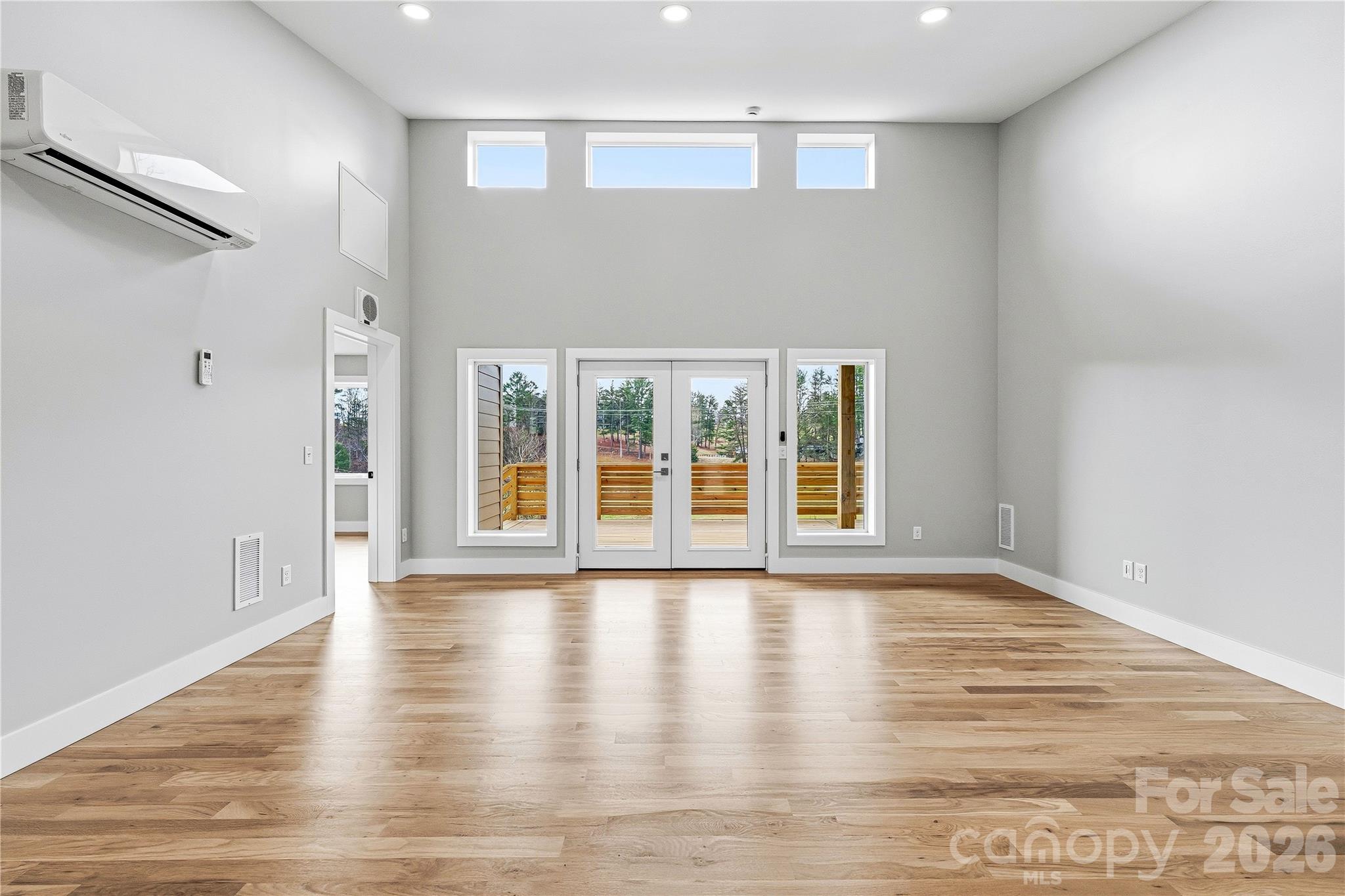 326 Emma Road Asheville, NC 28806 - Photo 4 of 15 a view of an empty room with wooden floor and a window