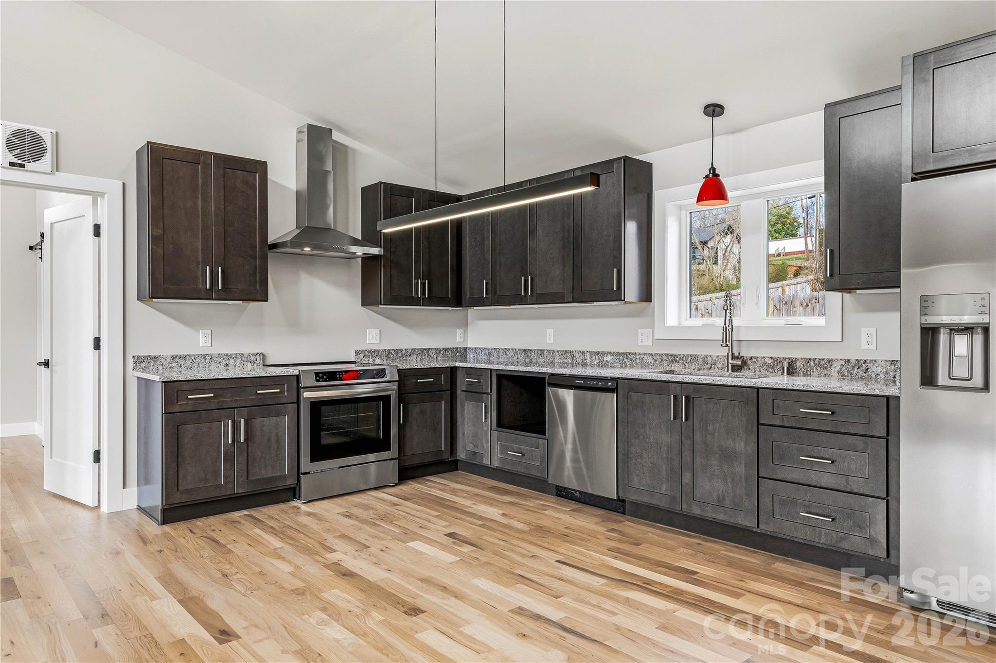 326 Emma Road Asheville, NC 28806 - Photo 6 of 15 a kitchen with stainless steel appliances kitchen island granite countertop a sink and stove top oven