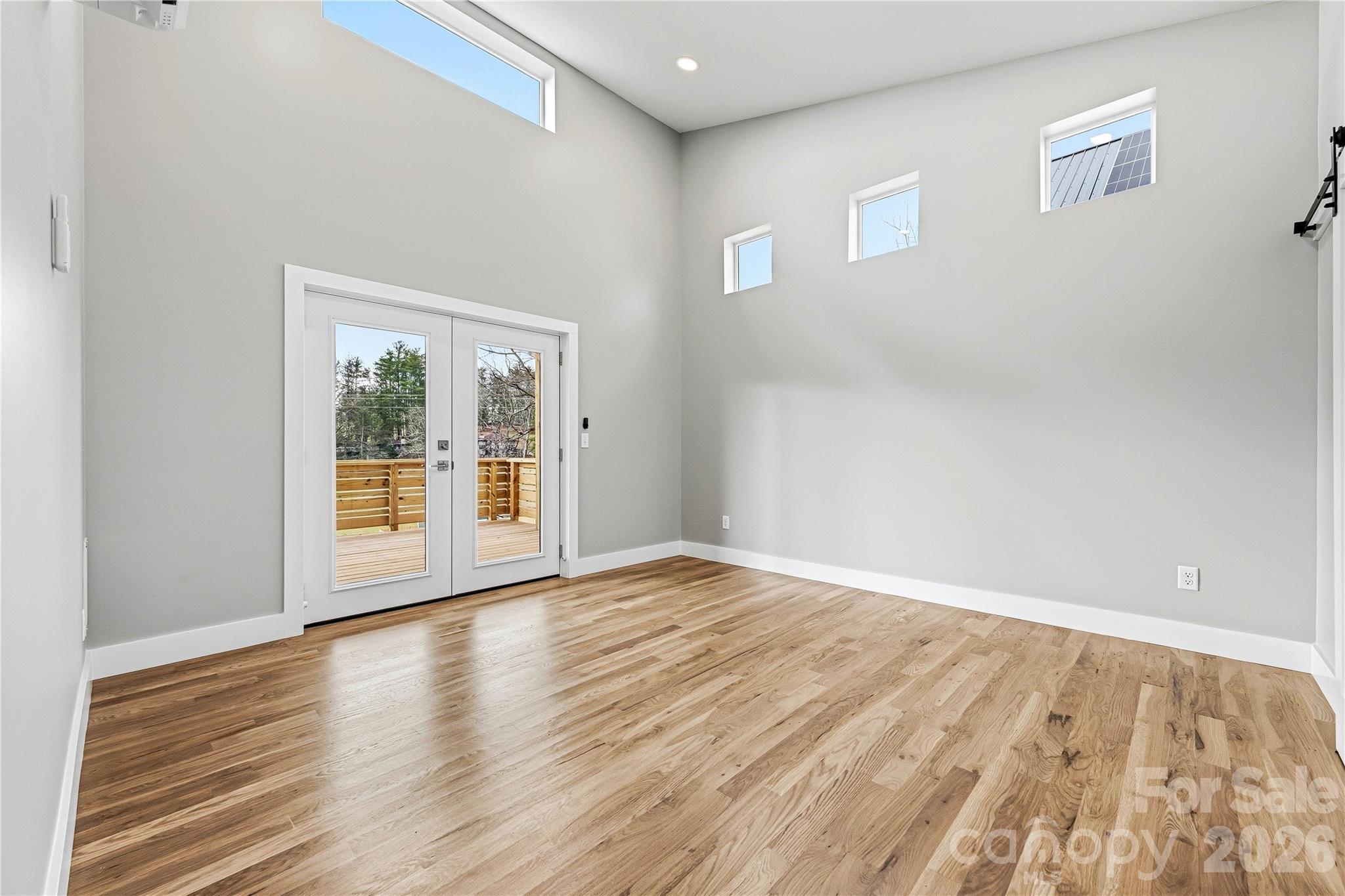 326 Emma Road Asheville, NC 28806 - Photo 7 of 15 a view of an empty room with wooden floor and a window