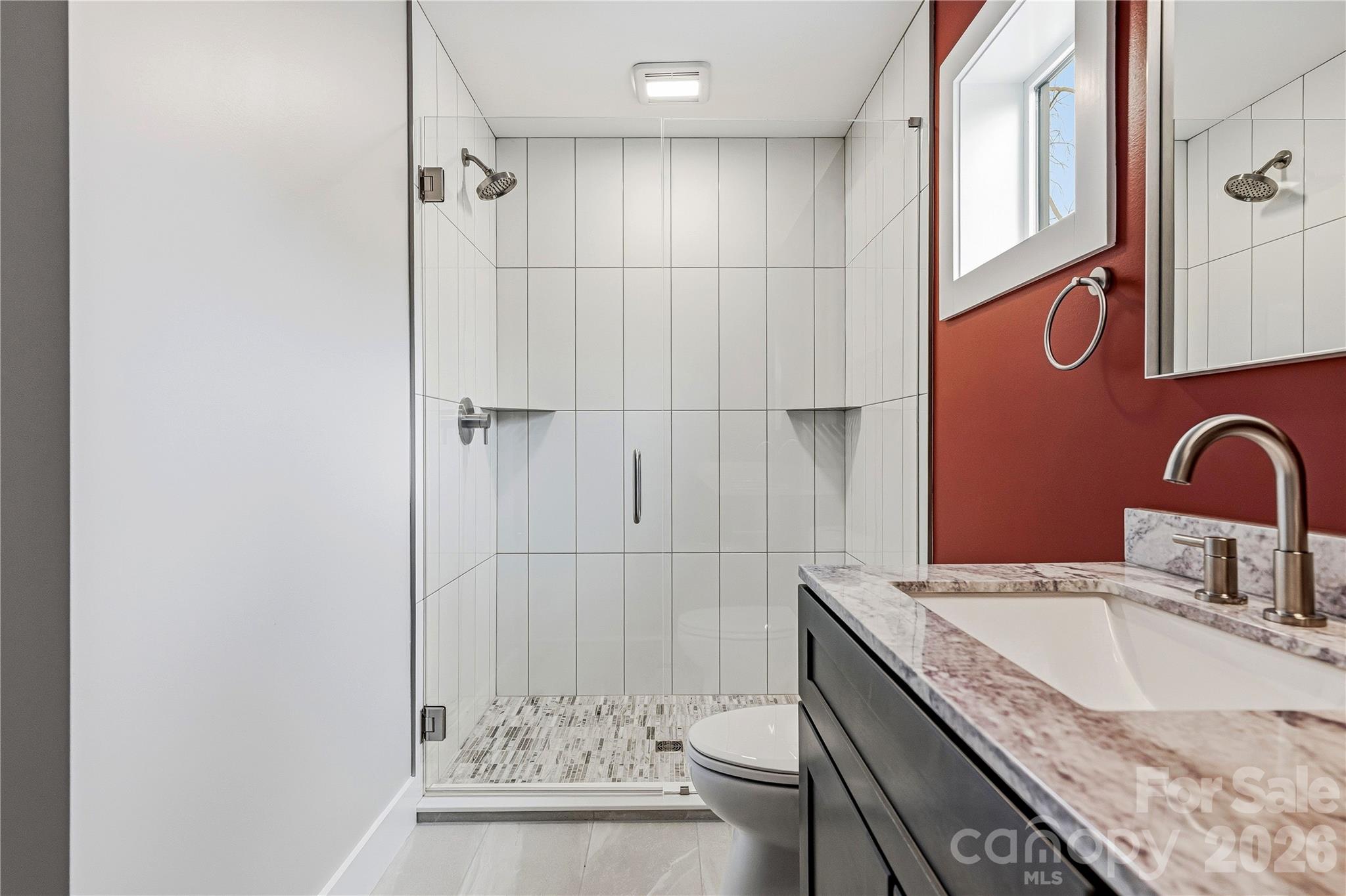 326 Emma Road Asheville, NC 28806 - Photo 10 of 15 a bathroom with a granite countertop sink a toilet and shower