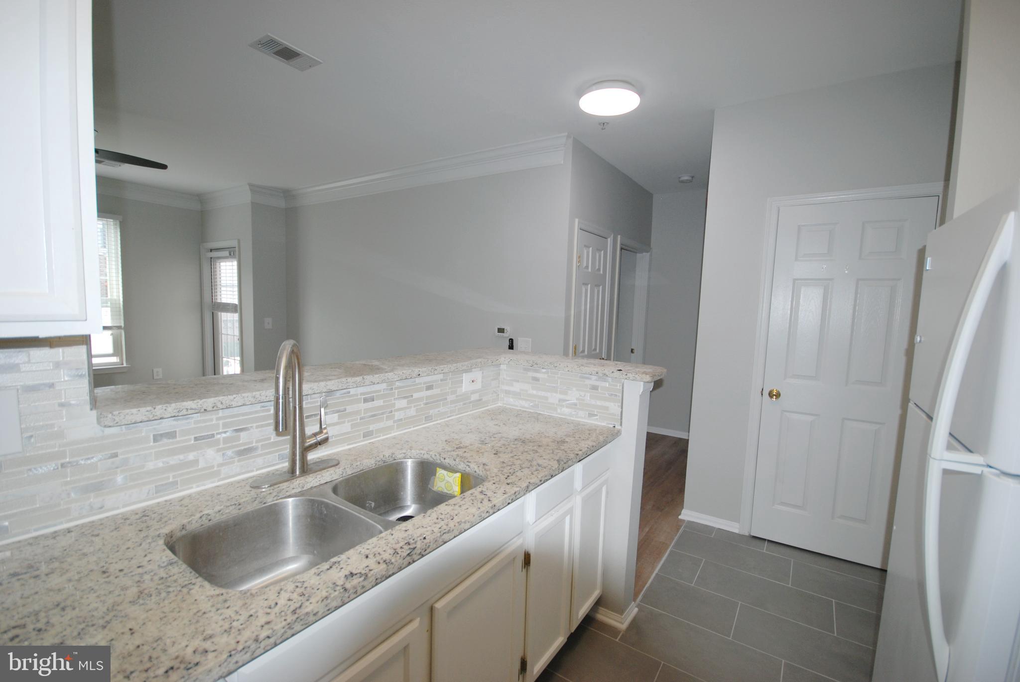 1571 Spring Gate Dr., Unit 6209 McLean, VA 22102 - Photo 9 of 31 a bathroom with a granite countertop sink and a mirror