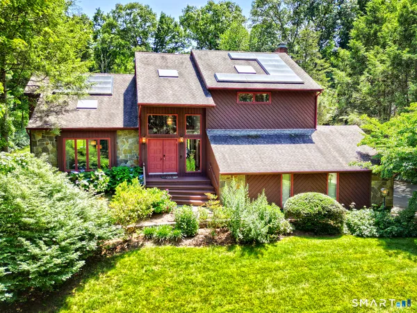 an aerial view of a house with yard and swimming pool