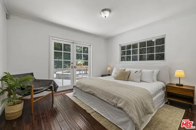 a spacious bedroom with a bed and a window