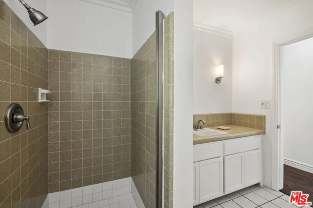 a bathroom with a granite countertop sink a toilet and shower