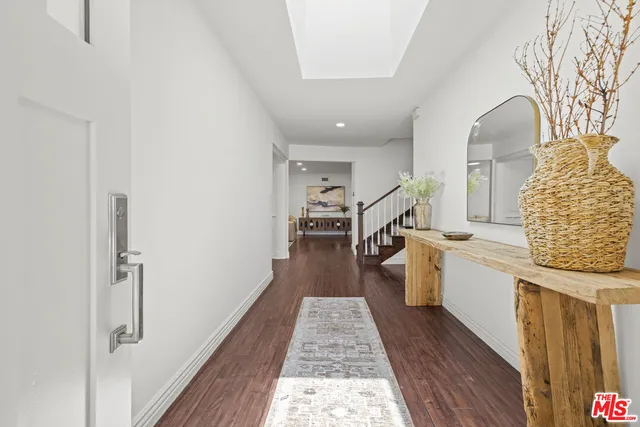 a kitchen with a sink and wooden floor