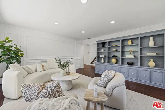 a living room with furniture and flowers
