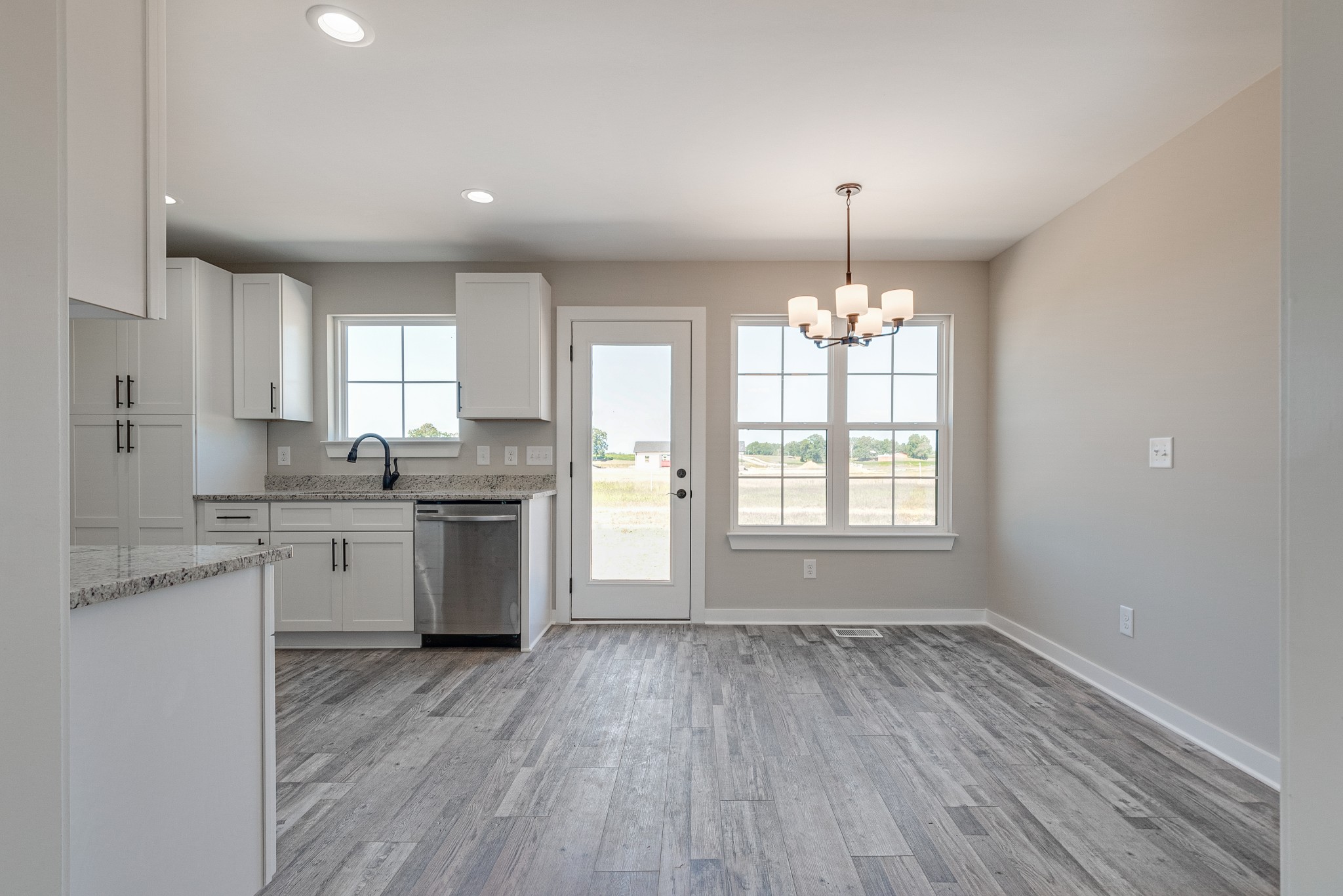 483 Meadows Road Portland, TN 37148 - Photo 11 of 29 a open kitchen with granite countertop white cabinets and white appliances