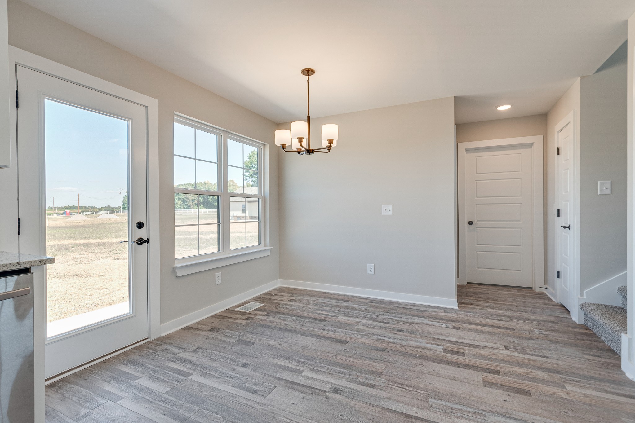 483 Meadows Road Portland, TN 37148 - Photo 12 of 29 a view of an empty room with wooden floor and a window
