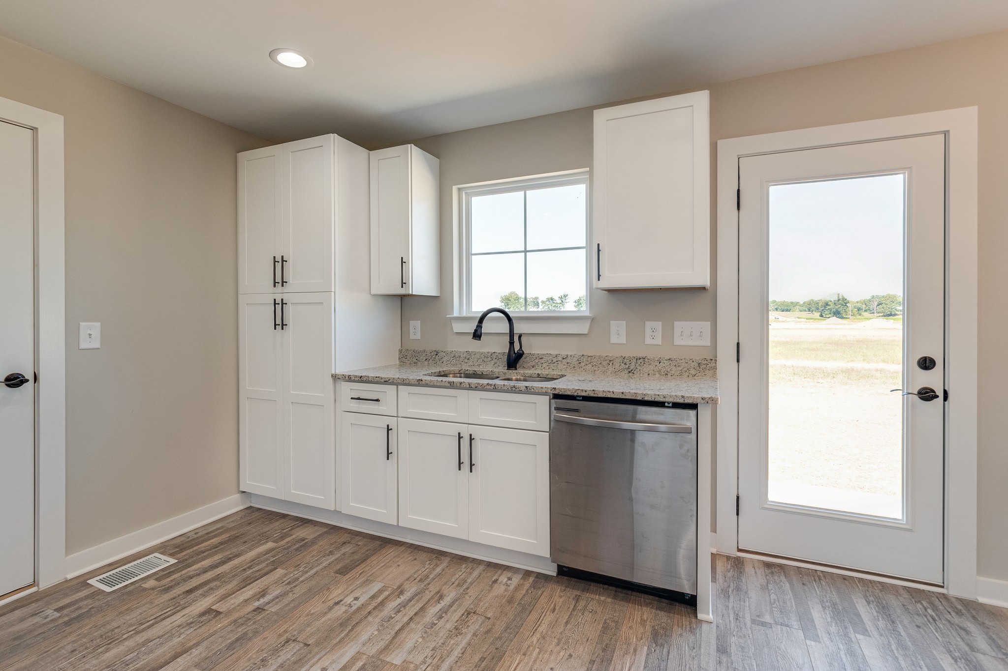 483 Meadows Road Portland, TN 37148 - Photo 16 of 29 a kitchen with granite countertop white cabinets sink and stainless steel appliances
