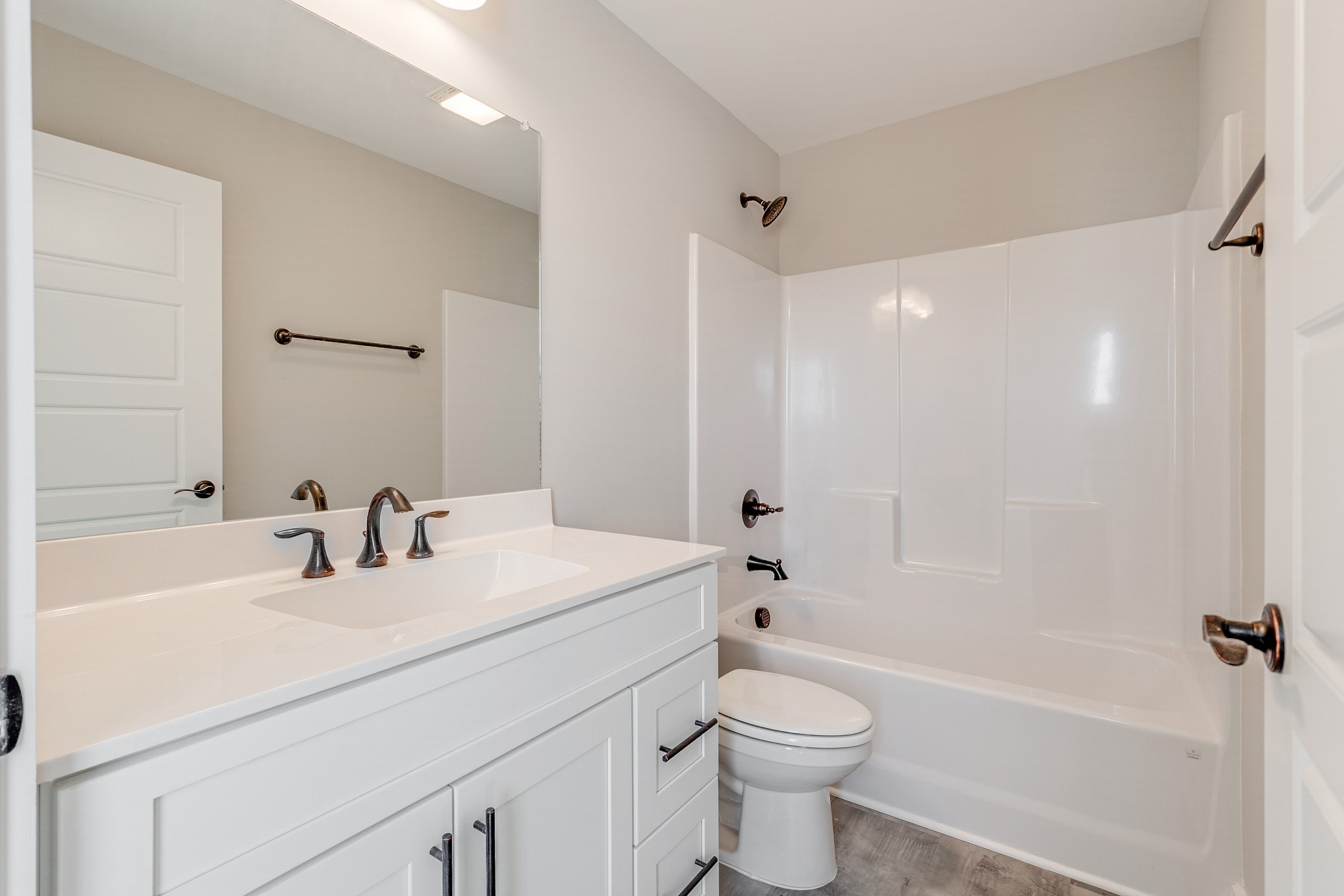483 Meadows Road Portland, TN 37148 - Photo 26 of 29 a bathroom with a sink a toilet a mirror a bathtub and shower