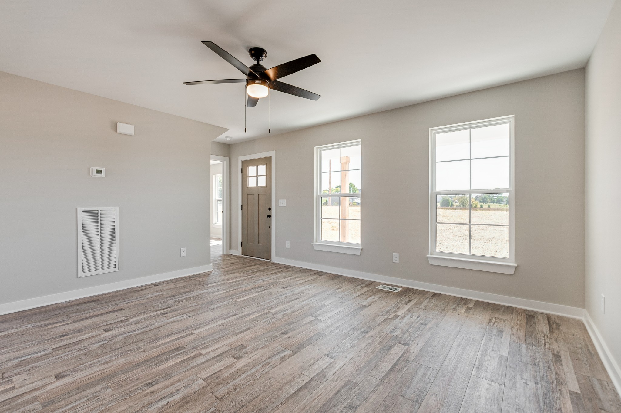 483 Meadows Road Portland, TN 37148 - Photo 8 of 29 a view of an empty room with wooden floor and a window