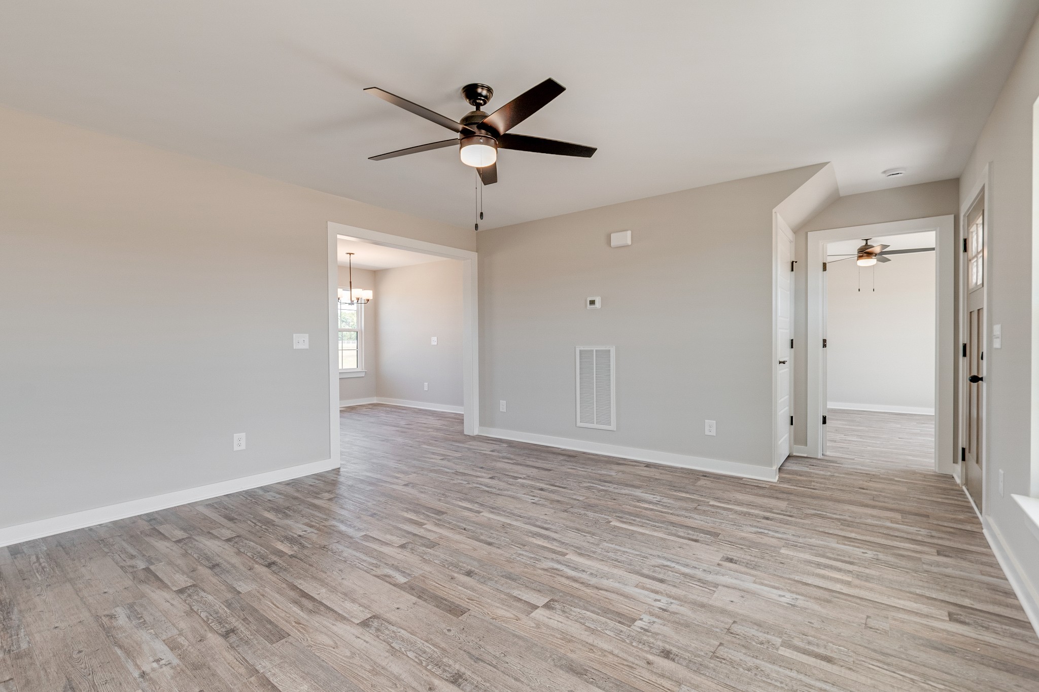 483 Meadows Road Portland, TN 37148 - Photo 9 of 29 a view of a livingroom with wooden floor and a ceiling fan