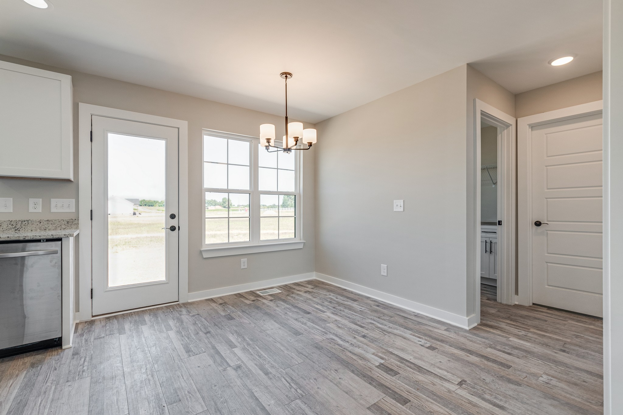 483 Meadows Road Portland, TN 37148 - Photo 10 of 29 a view of an empty room with window and wooden floor