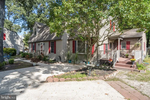a front view of a house with porch and sitting area