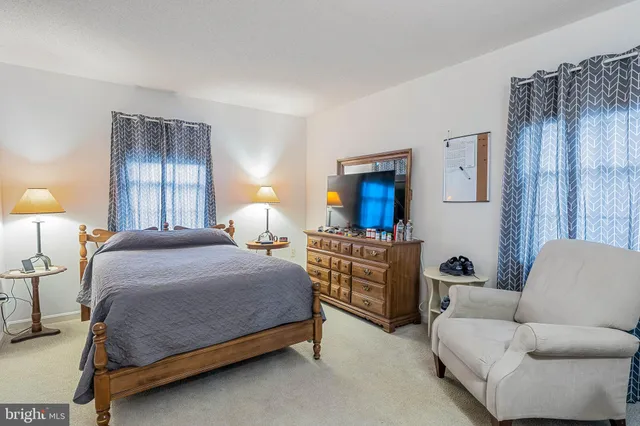 a bed room with furniture and a flat screen tv