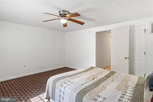 a view of a kitchen with fridge and wooden floor