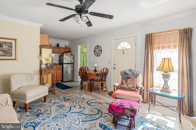a view of a patio with table and chairs with wooden floor and fence