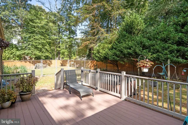 a view of a patio with a table chairs and a barbeque