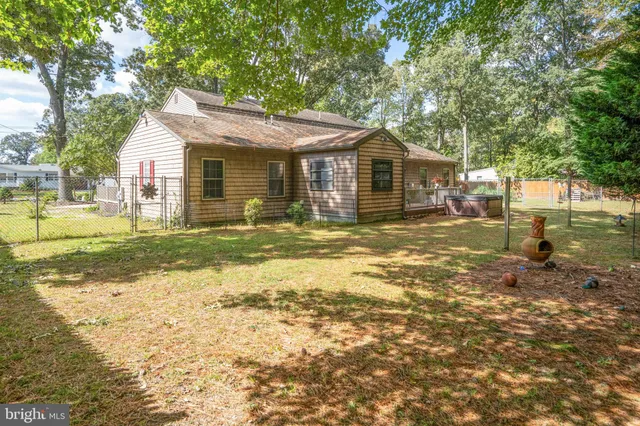 a backyard of a house with lots of green space and a water fountain