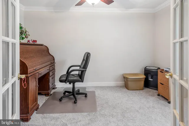 a view of a workspace with furniture and a window