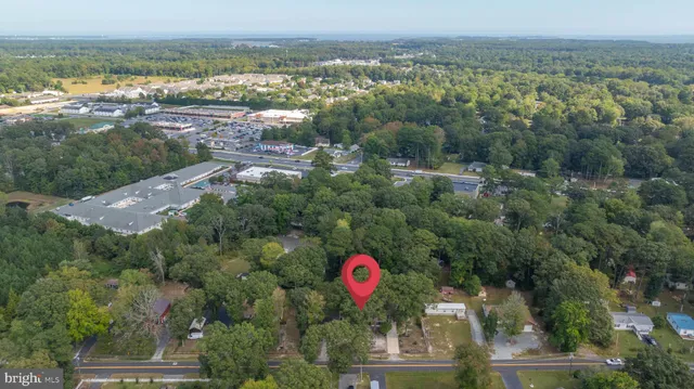 a view of a brick house with many windows next to a road