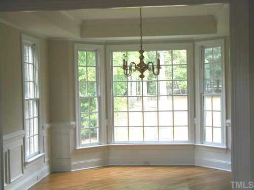 5212 Azure Lane Raleigh, NC 27613 - Photo 3 of 10 Formal Dining Room has trey ceiling, hardwoods, wainscote, chair rail, dentil crown molding, walk out bay window and overlooks back yard. Other