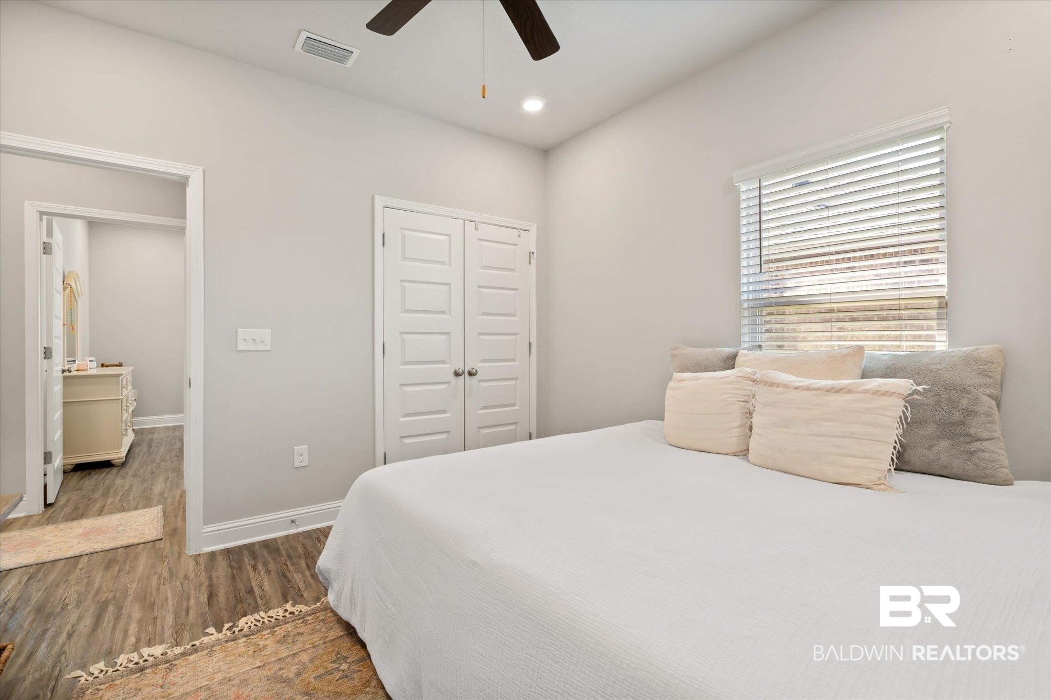 12899 Sanderling Loop Daphne, AL 36527 - Photo 18 of 28 Bedroom with a closet, dark wood-type flooring, and ceiling fan