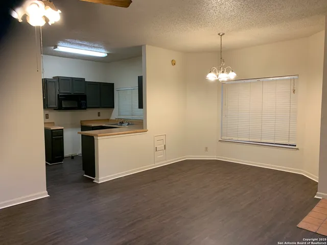 a view of a room with a flat screen tv and kitchen view