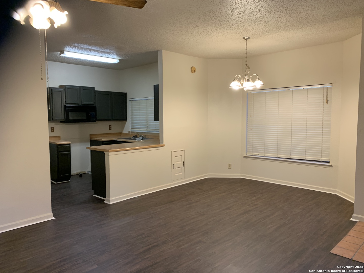 8441 Forest Ridge Drive, Unit 80 San Antonio, TX 78239 - Photo 3 of 10 a view of a room with a flat screen tv and kitchen view