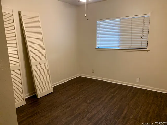 an empty room with wooden floor