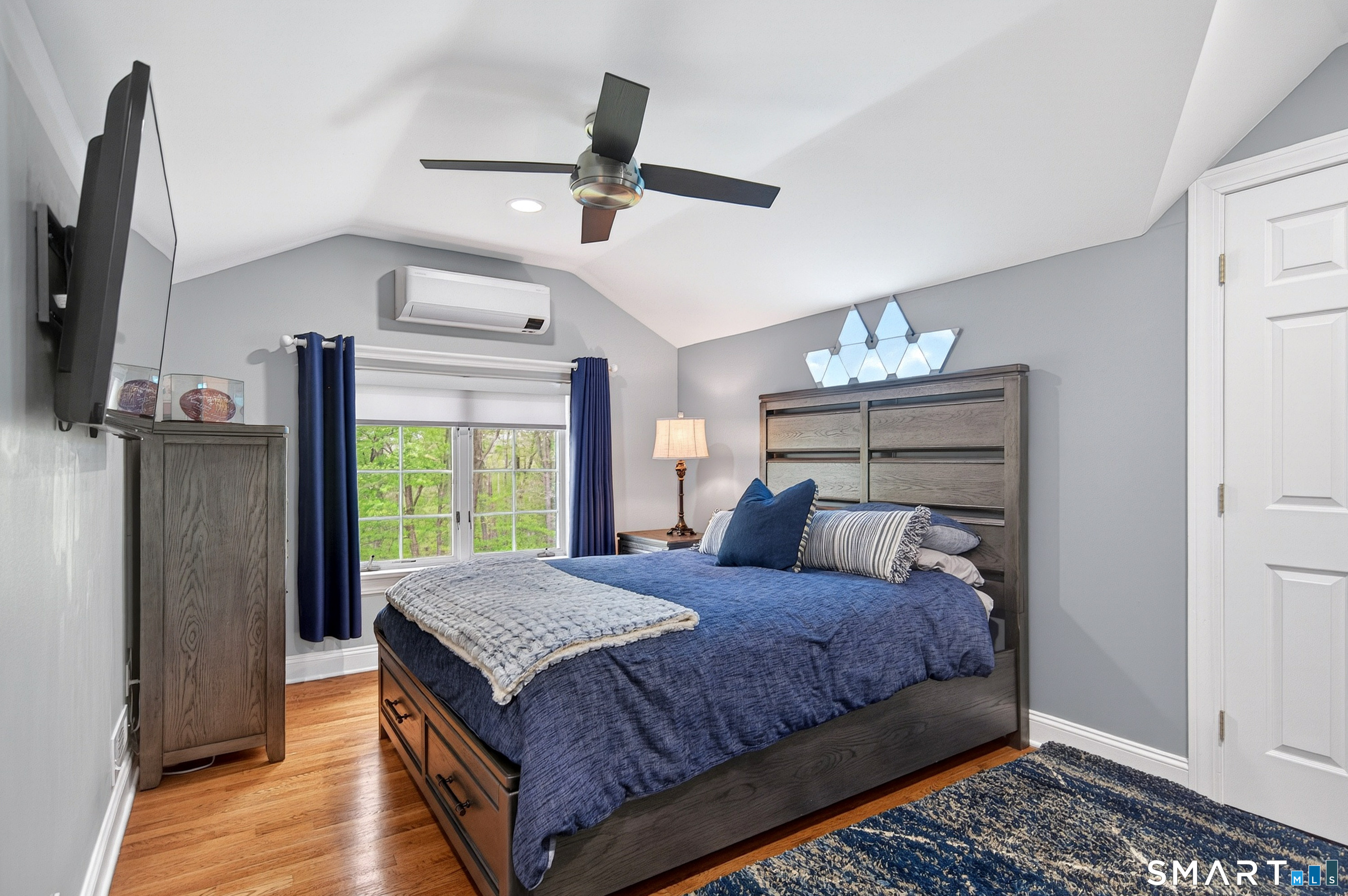 16 Farm Meadow Road Newtown, CT 06470 - Photo 22 of 40 Stylish bedroom retreat with vaulted ceilings, hardwood floors, mini-split system, and modern finishes.