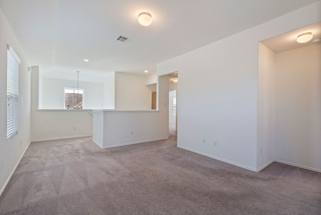 156 Red Buckeye Loop Liberty Hill, TX 78642 - Photo 11 of 27 a view of kitchen and empty room