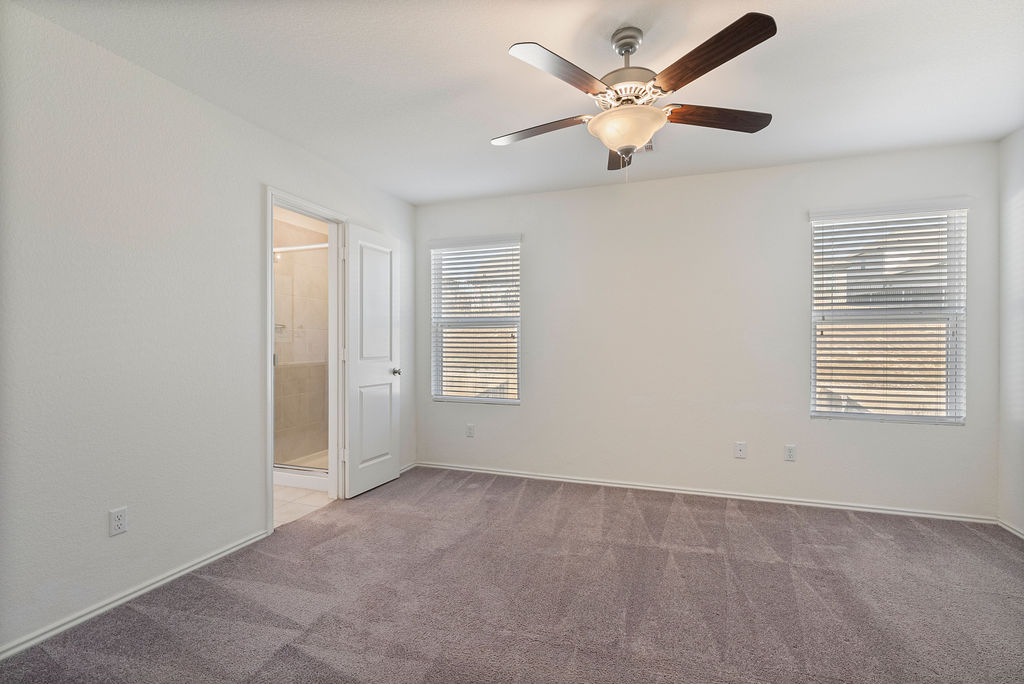 156 Red Buckeye Loop Liberty Hill, TX 78642 - Photo 12 of 27 a view of an empty room with a ceiling fan