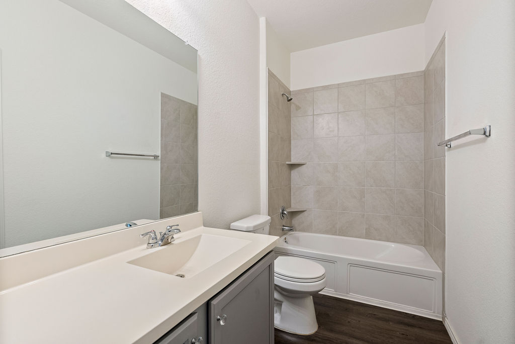 156 Red Buckeye Loop Liberty Hill, TX 78642 - Photo 15 of 27 a bathroom with a toilet a sink and a bathtub