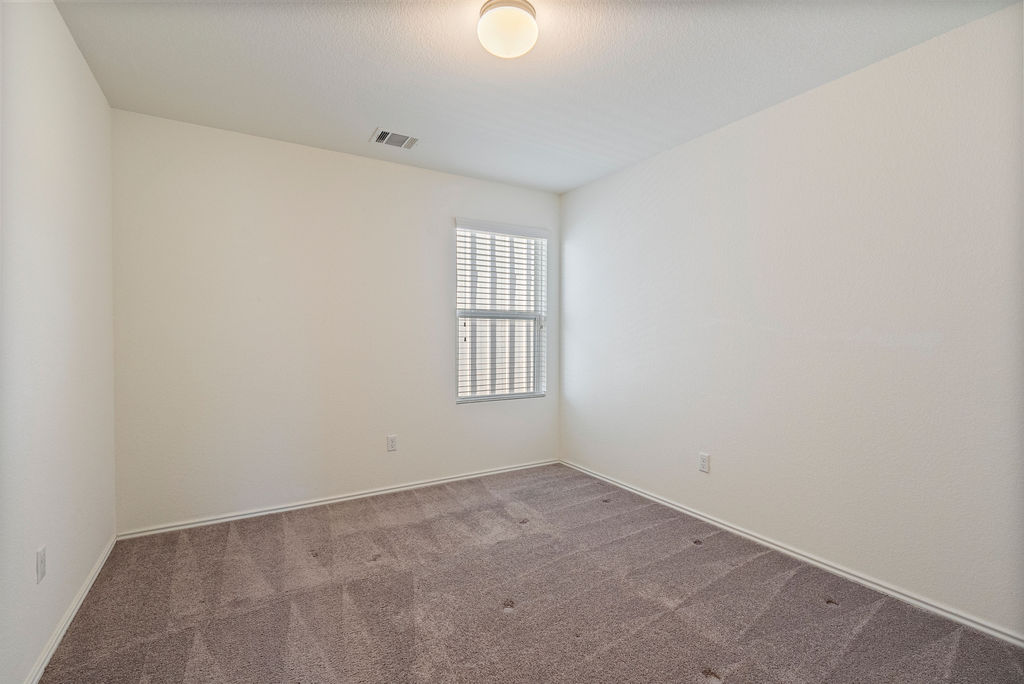 156 Red Buckeye Loop Liberty Hill, TX 78642 - Photo 21 of 27 an empty room with windows