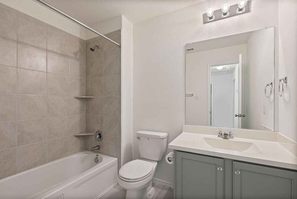 156 Red Buckeye Loop Liberty Hill, TX 78642 - Photo 23 of 27 a bathroom with a sink toilet and shower