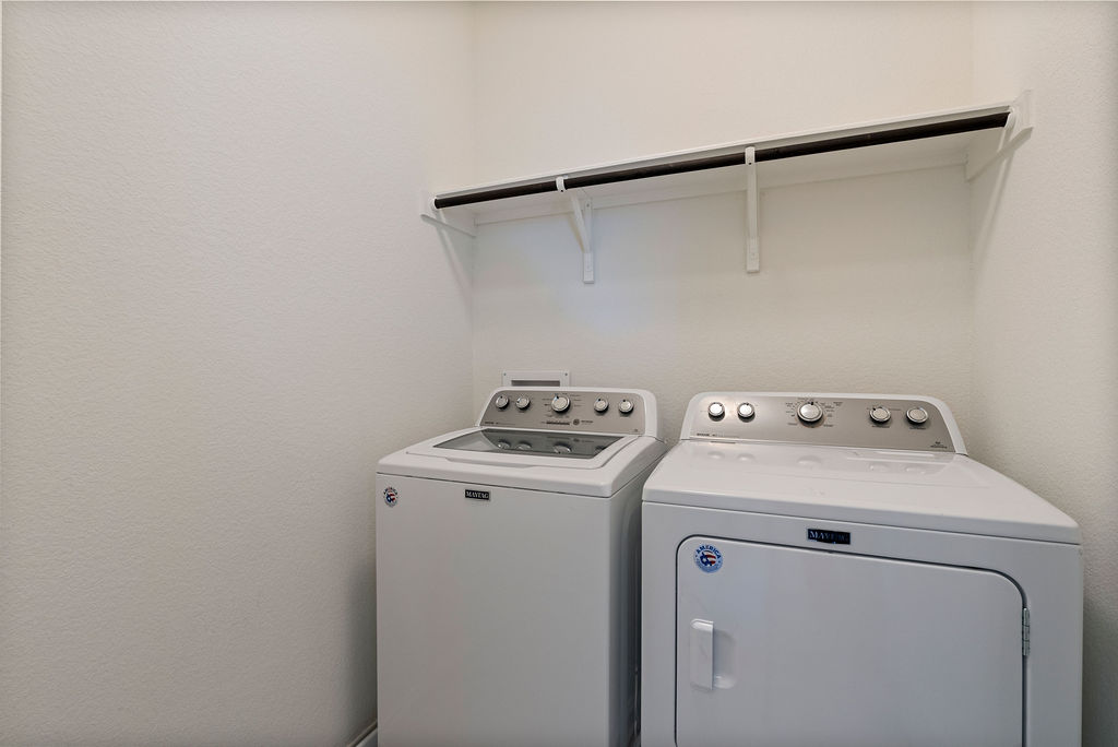 156 Red Buckeye Loop Liberty Hill, TX 78642 - Photo 25 of 27 a utility room with dryer and washer