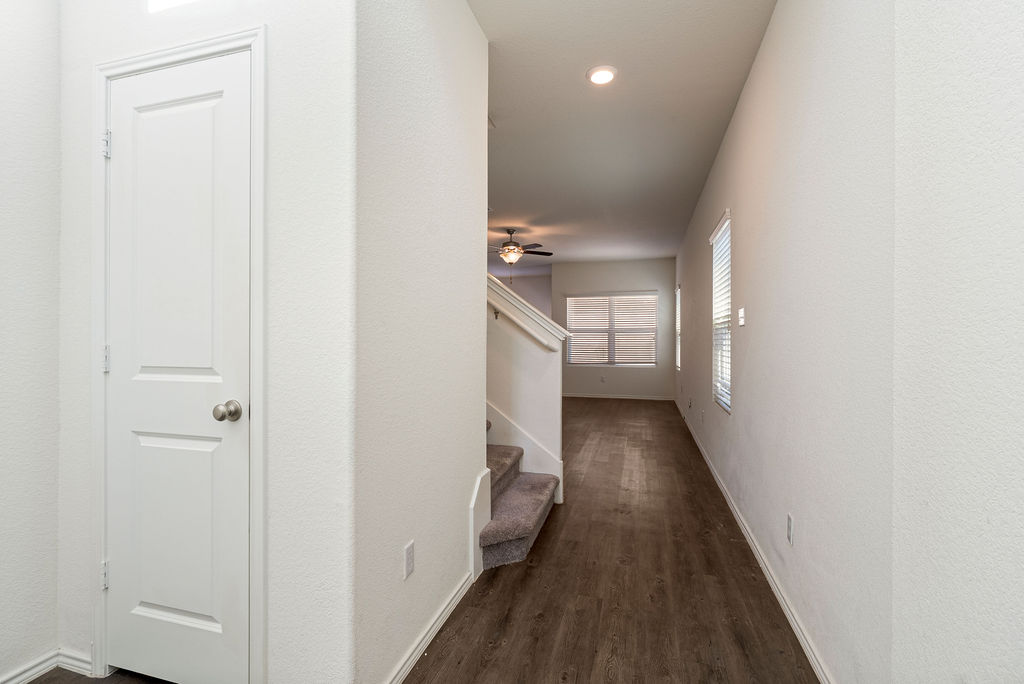 156 Red Buckeye Loop Liberty Hill, TX 78642 - Photo 9 of 27 a view of a hallway with wooden floor