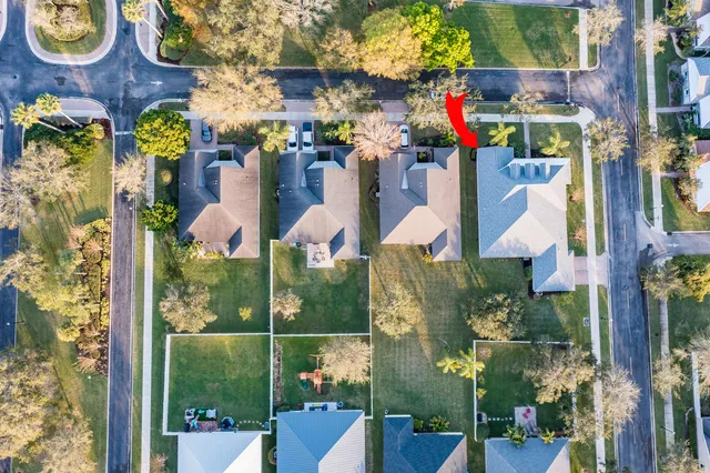 a view of an empty room with a window and a fireplace