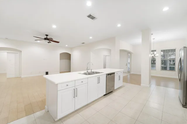 a large white bathroom with a large mirror vanity and shower