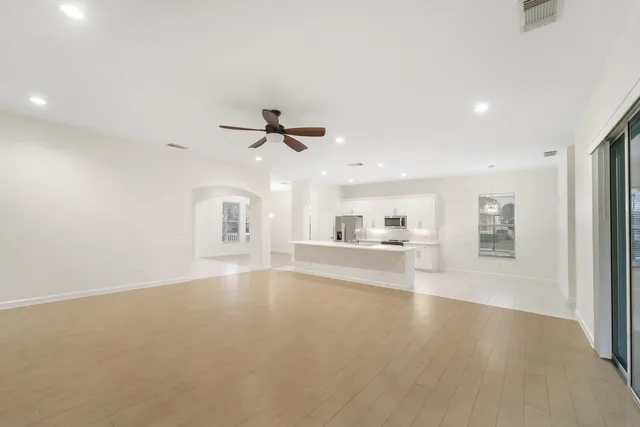 a view of a livingroom with a ceiling fan and window