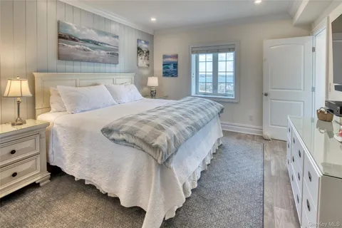 a spacious bedroom with a bed and a window