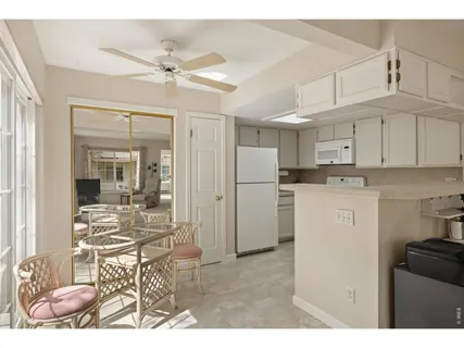 a kitchen with refrigerator cabinets and a dining table