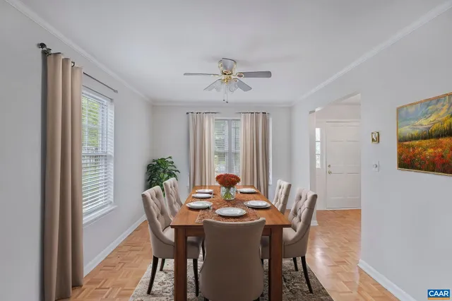 a dining room with furniture window and wooden floor