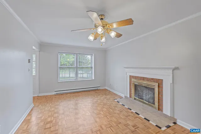 a view of an empty room with a fireplace and a window
