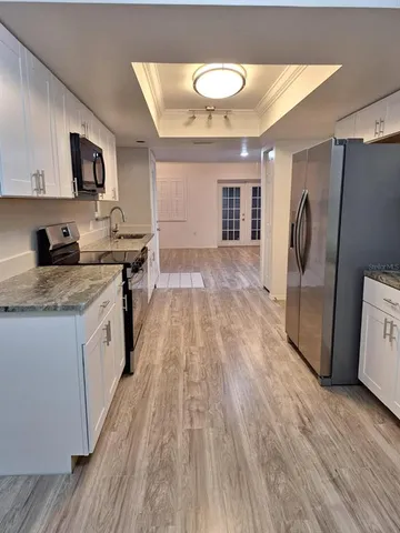 a kitchen with a refrigerator a sink and a microwave