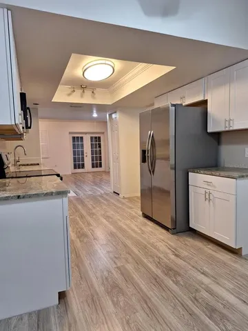 a kitchen with stainless steel appliances granite countertop a stove a sink and a refrigerator